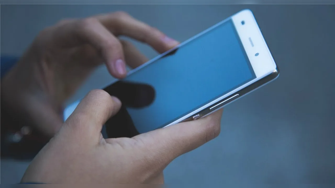Hands holding a white smartphone
